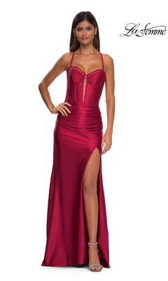 A woman stands against a white background in the La Femme 32683 Lace-Up Long Satin Prom Dress, a fitted red gown featuring thin straps, a corset-style bodice, and a thigh-high slit.