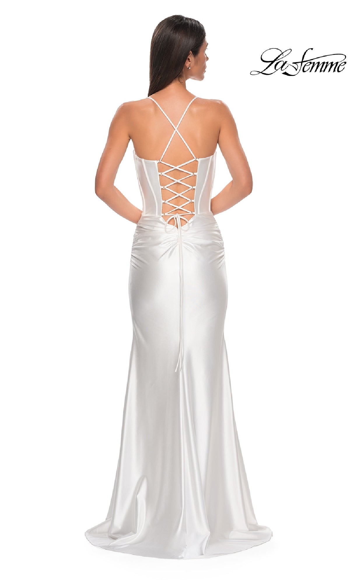 A woman stands facing away in the La Femme 32683 Lace-Up Long Satin Prom Dress, featuring a corset bodice, lace-up back, and thin crisscross straps. The 
