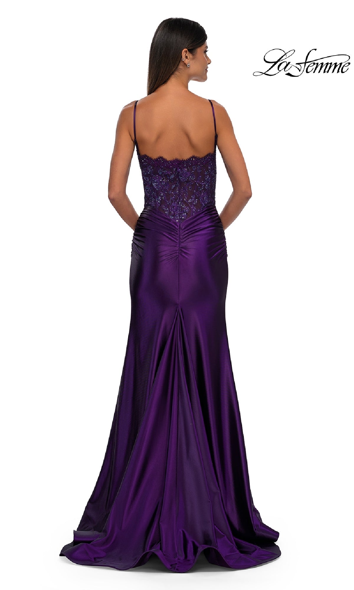 A woman poses against a white background in the La Femme 32689 Glitter-Bodice Long Prom Dress, featuring a floor-length purple satin skirt, lace-back detailing, thin straps, and a flowing train.