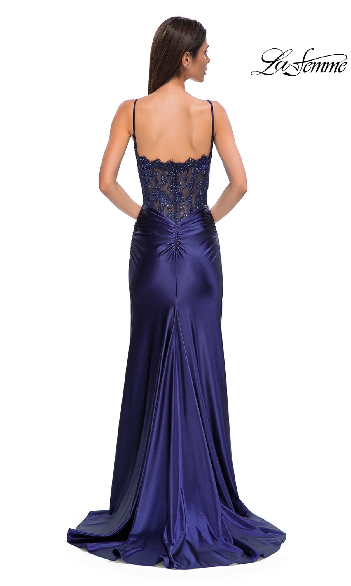 A woman wearing the La Femme 32689 Glitter-Bodice Long Prom Dress, featuring a floor-length skirt and sparkling details, stands with her back to the camera.