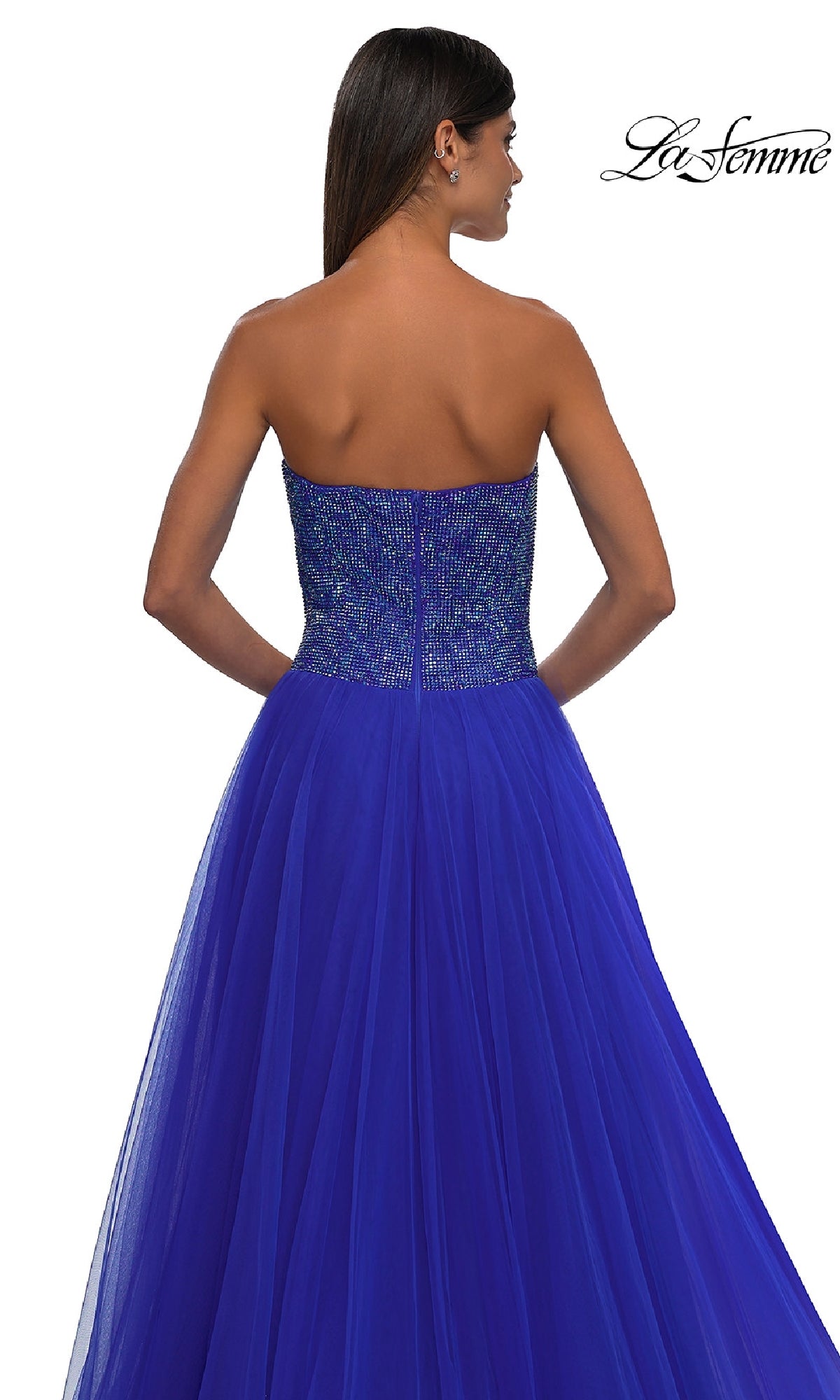 A woman models the La Femme 32690: a strapless long prom ball gown with a beaded sweetheart bodice and tulle skirt. The La Femme logo appears in the upper right corner.
