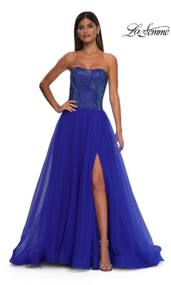 A woman poses with one hand on her hip in the Strapless Long Prom Ball Gown "La Femme 32690," featuring a sweetheart bodice, sequined details, sheer skirt, and thigh-high slit. La Femme logo appears in the top right corner.