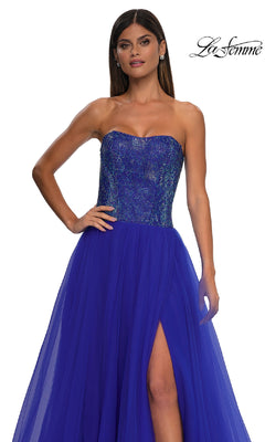 A woman models the Strapless Long Prom Ball Gown La Femme 32690 in royal blue, featuring a sweetheart beaded bodice, sheer tulle skirt with thigh-high slit. The La Femme logo appears in the top right corner.