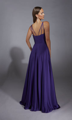 A woman in the Aerie Couture 326 long formal dress stands facing away, displaying its sleeveless, floor-length a-line silhouette, thin straps, open back, and flowing skirt against a plain gray background.