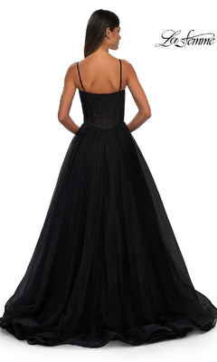 A woman stands facing away in the La Femme 32700 Tulle Prom Ball Gown with pockets, featuring a long black tulle a-line skirt and thin straps. The background is white with the "La Femme" logo in the top right corner.