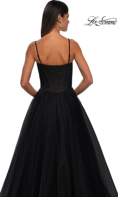 A woman is shown from the back in the La Femme 32700 Tulle Prom Ball Gown with Pockets, featuring a black sleeveless design with thin straps, a fitted bodice, and an elegant A-line skirt against a white background.
