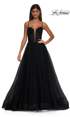 A woman models the La Femme 32700 Tulle Prom Ball Gown with Pockets, featuring a black floor-length tulle skirt and sheer corset bodice, against a white background. The "La Femme" logo appears in the top right corner.