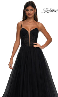 A woman models the La Femme 32700 Tulle Prom Ball Gown with Pockets, featuring a black strapless structured bodice and elegant A-line skirt, against a plain white background with the "La Femme" logo in the top right corner.
