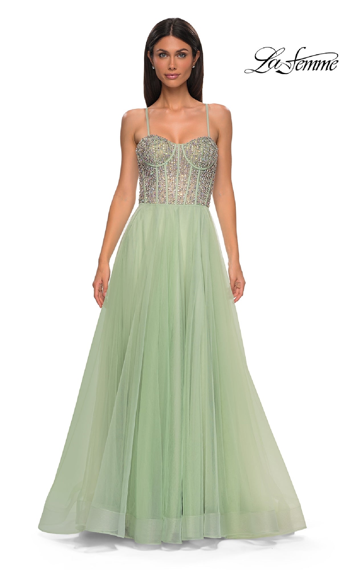 A woman models the Beaded-Corset Long Prom Dress: La Femme 32703—a light green, floor-length gown with rhinestone beaded corset bodice and thin straps—against a white background. The 