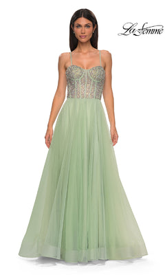 A woman models the Beaded-Corset Long Prom Dress: La Femme 32703—a light green, floor-length gown with rhinestone beaded corset bodice and thin straps—against a white background. The "La Femme" logo appears in the top right corner.