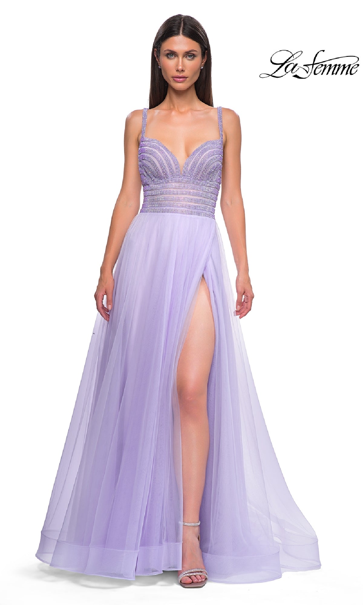 A woman models the La Femme 32714 Rhinestone-Bodice Prom Ball Gown, featuring a long tulle skirt, thin straps, and high slit, against a white background with the La Femme logo in the corner.