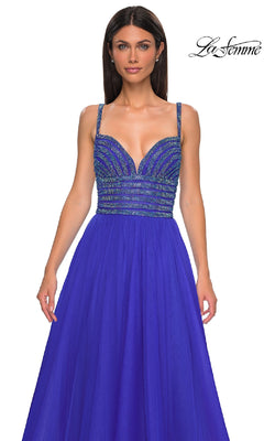 A woman wears the La Femme 32714 rhinestone-bodice prom ball gown in royal blue, featuring a sleeveless design and flowy skirt; "La Femme" logo in the top right corner.