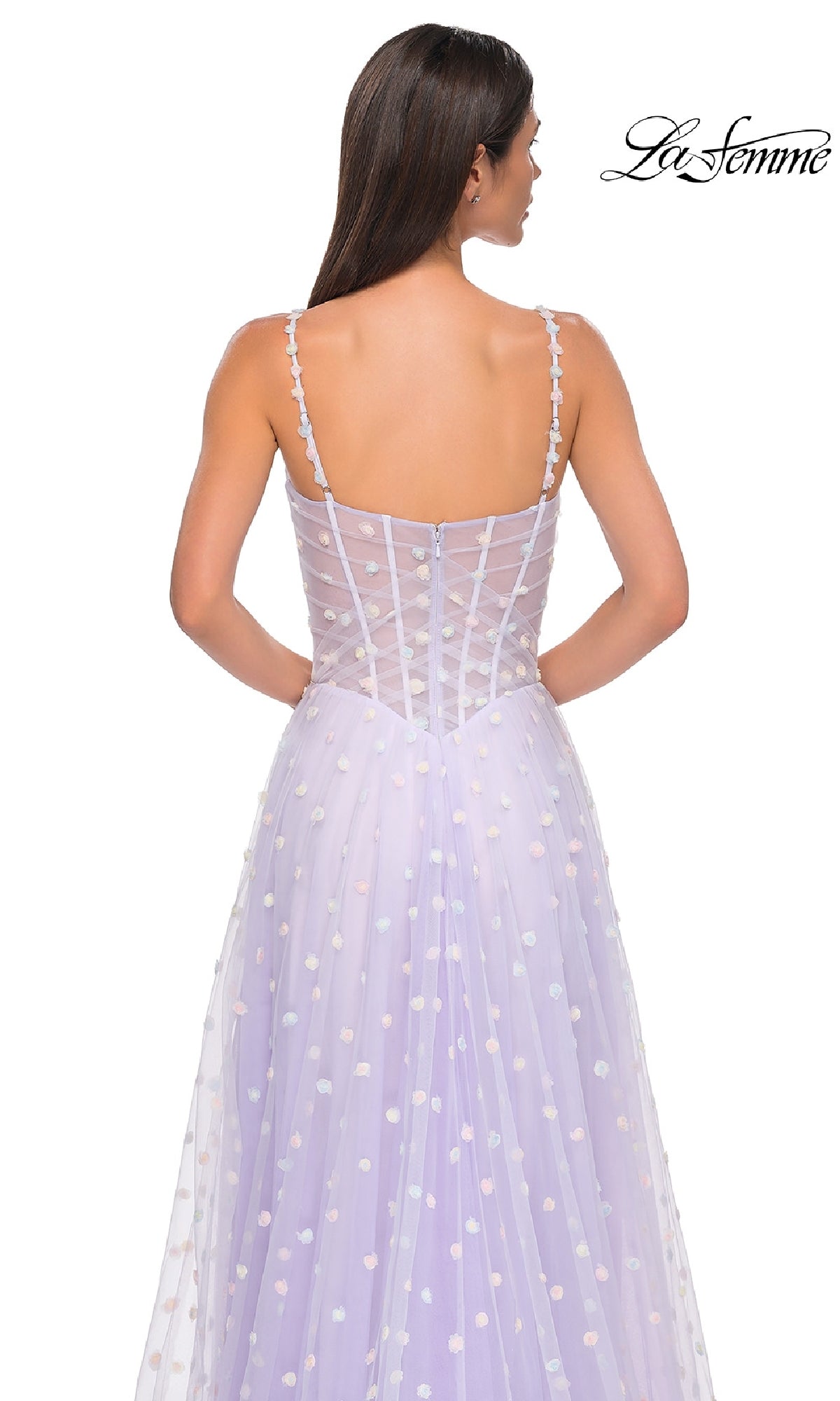A woman faces away, wearing the lilac Polka-Dot Long Prom Ball Gown: La Femme 32716 with thin straps and polka dot details. The 