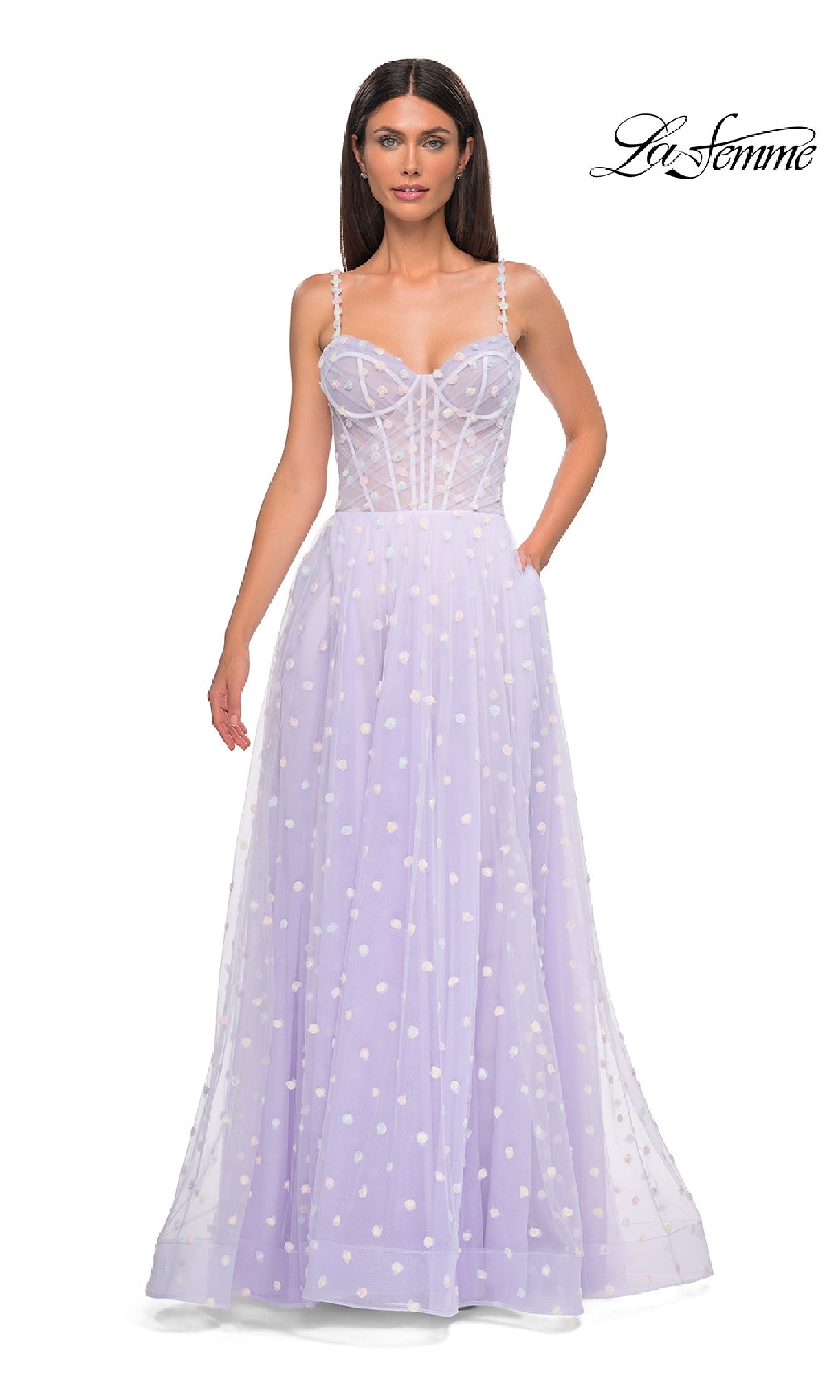 A woman wears the La Femme 32716 Polka-Dot Long Prom Ball Gown in light periwinkle, featuring spaghetti straps, a fitted bodice, white polka dots, and a sheer overlay. The La Femme logo appears in the top right corner.