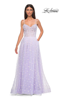 A woman wears the La Femme 32716 Polka-Dot Long Prom Ball Gown in light periwinkle, featuring spaghetti straps, a fitted bodice, white polka dots, and a sheer overlay. The La Femme logo appears in the top right corner.