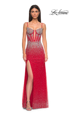 A woman models the La Femme 32717 long prom dress—red, sparkling, with thin straps, a corset bodice, high slit, and sheer panels—standing before a white background with the "La Femme" logo.