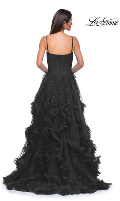 A woman is photographed from the back in a black, floor-length ruffled-tulle A-line prom ball gown with spaghetti straps (La Femme 32719), against a white background. The La Femme logo is shown in the top right corner.