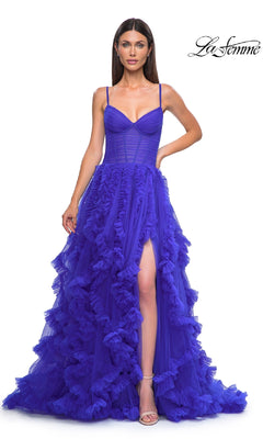 A woman poses against a white background with the "La Femme" logo, wearing the Ruffled-Tulle Long Prom Ball Gown: La Femme 32719—a vibrant purple dress with spaghetti straps, a fitted bodice, and a high slit.