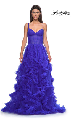 A woman wears the La Femme 32719 Ruffled-Tulle Long Prom Ball Gown in royal blue, featuring thin straps, a fitted lace corset bodice, and a layered ruffled tulle skirt. "La Femme" is displayed in the top right on a white background.