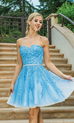 A woman wearing the Embroidered Short Strapless Semi-Formal Prom Dress stands outdoors, smiling and holding the skirt of her fit-and-flare party dress.