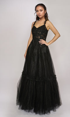 A woman wears the Nina Canacci 3272 long formal dress, showcasing a sleeveless lace-fitted bodice and flared tulle skirt against a plain light background.