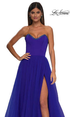 A woman models the La Femme 32731 strapless long prom ball gown in royal blue, featuring a sweetheart neckline with beaded detail and a thigh-high slit, posed against a plain white background.