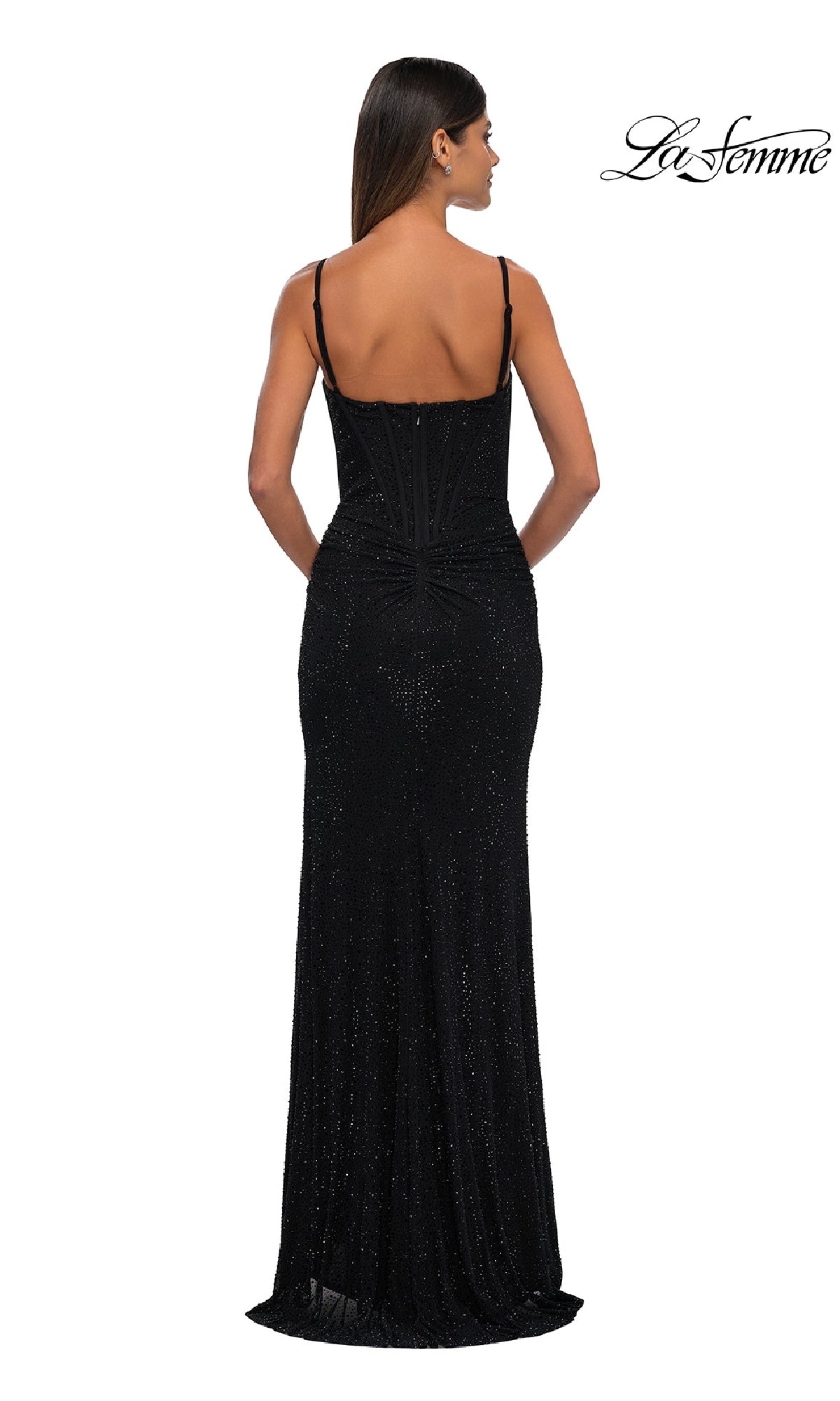 A woman faces away in a fitted, floor-length Classic Long Beaded Prom Dress: La Femme 32753 with thin straps, highlighting its stunning back details. The La Femme logo is visible in the top right corner.