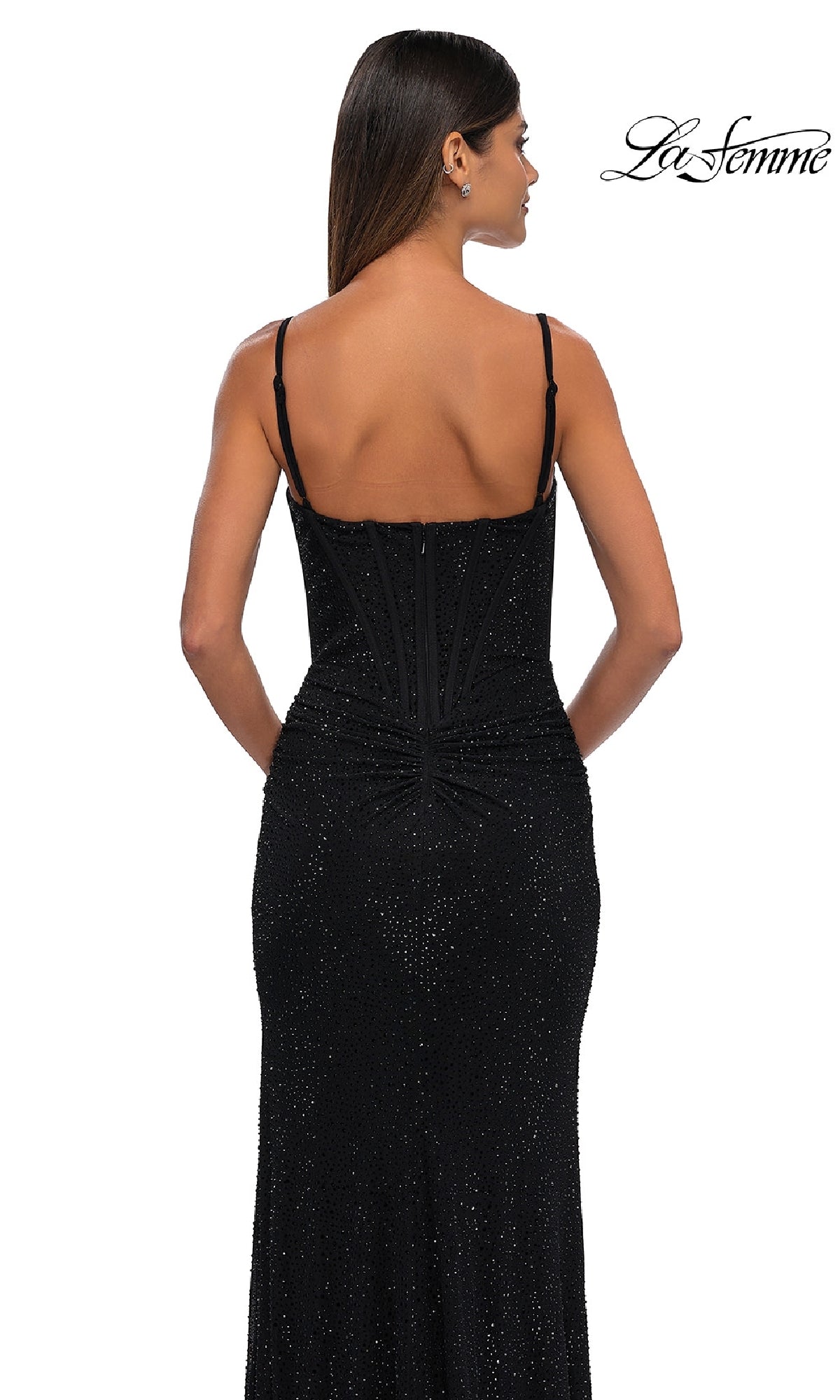 Woman models the Classic Long Beaded Prom Dress, La Femme 32753— a fitted black gown with sparkling beads and thin straps, shown from the back on a white background. 
