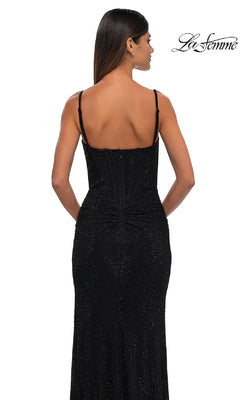 Woman models the Classic Long Beaded Prom Dress, La Femme 32753— a fitted black gown with sparkling beads and thin straps, shown from the back on a white background. "La Femme" logo appears in the upper right corner.