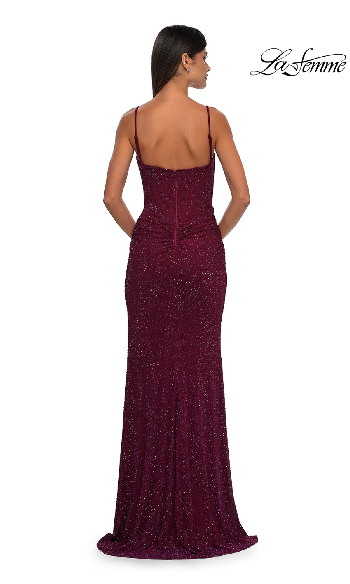 A woman is shown from the back in a sleeveless, floor-length Classic Long Beaded Prom Dress (La Femme 32753) with thin straps and subtle sparkles. The 