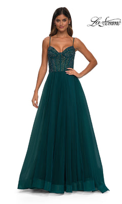 A woman models the La Femme 32754 Beaded-Bodice Long Prom Dress, featuring a floor-length dark green gown with thin straps and a full tulle skirt, against a plain white backdrop. "La Femme" logo appears in the top right corner.