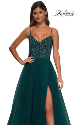 Woman wearing La Femme 32754, a beaded-bodice long prom dress with rhinestone details, spaghetti straps, fitted bodice, tulle skirt, and thigh-high slit. "La Femme" logo in the top right corner.