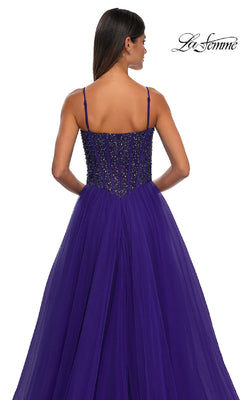 A woman models the Beaded-Bodice Long Prom Dress: La Femme 32754 in deep purple, featuring thin straps and a fitted beaded bodice. Shown from the back on a white background with the La Femme logo displayed in the corner.