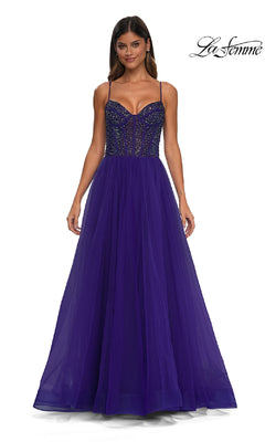 A woman wearing the Beaded-Bodice Long Prom Dress (La Femme 32754), featuring a floor-length deep purple design with thin straps, a sequin-embellished structured bodice, and a flowing tulle skirt.