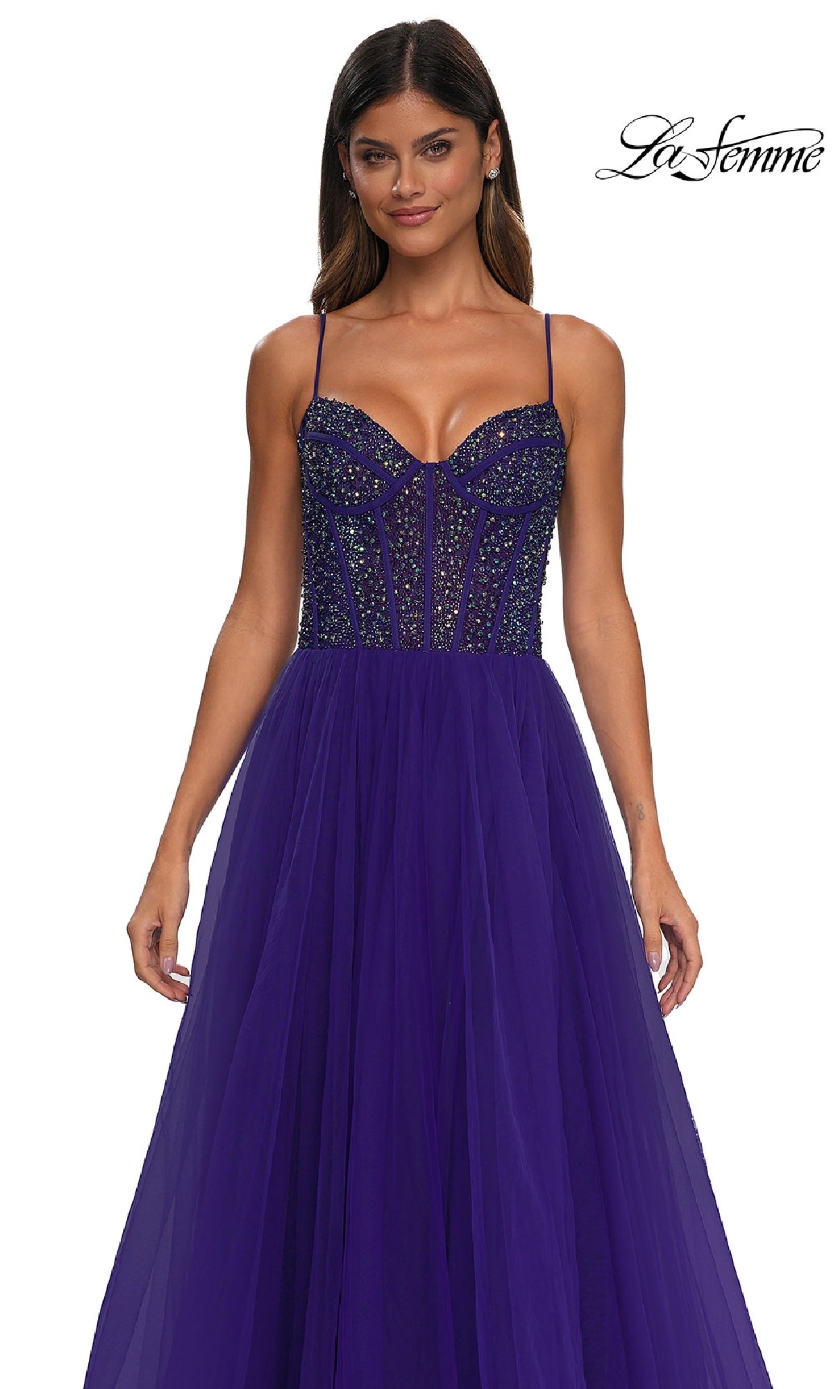 Woman wearing a Beaded-Bodice Long Prom Dress: La Femme 32754 in deep purple, featuring rhinestone embellishments, sheer tulle skirt, thin straps, and structured fit; 