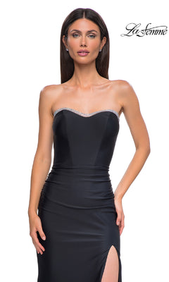 A woman in the Bead-Trimmed Strapless Prom Gown (La Femme 32756) stands against a white background. The long dress features silver bead trim at the neckline and a thigh-high slit.