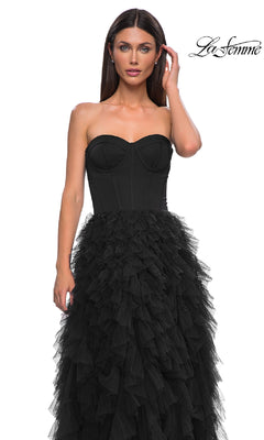 A woman models the La Femme 32760 Strapless Long Ruffled Prom Dress, featuring a corset-style bodice and layered tulle skirt, posed against a white background with the La Femme logo in the top right corner.