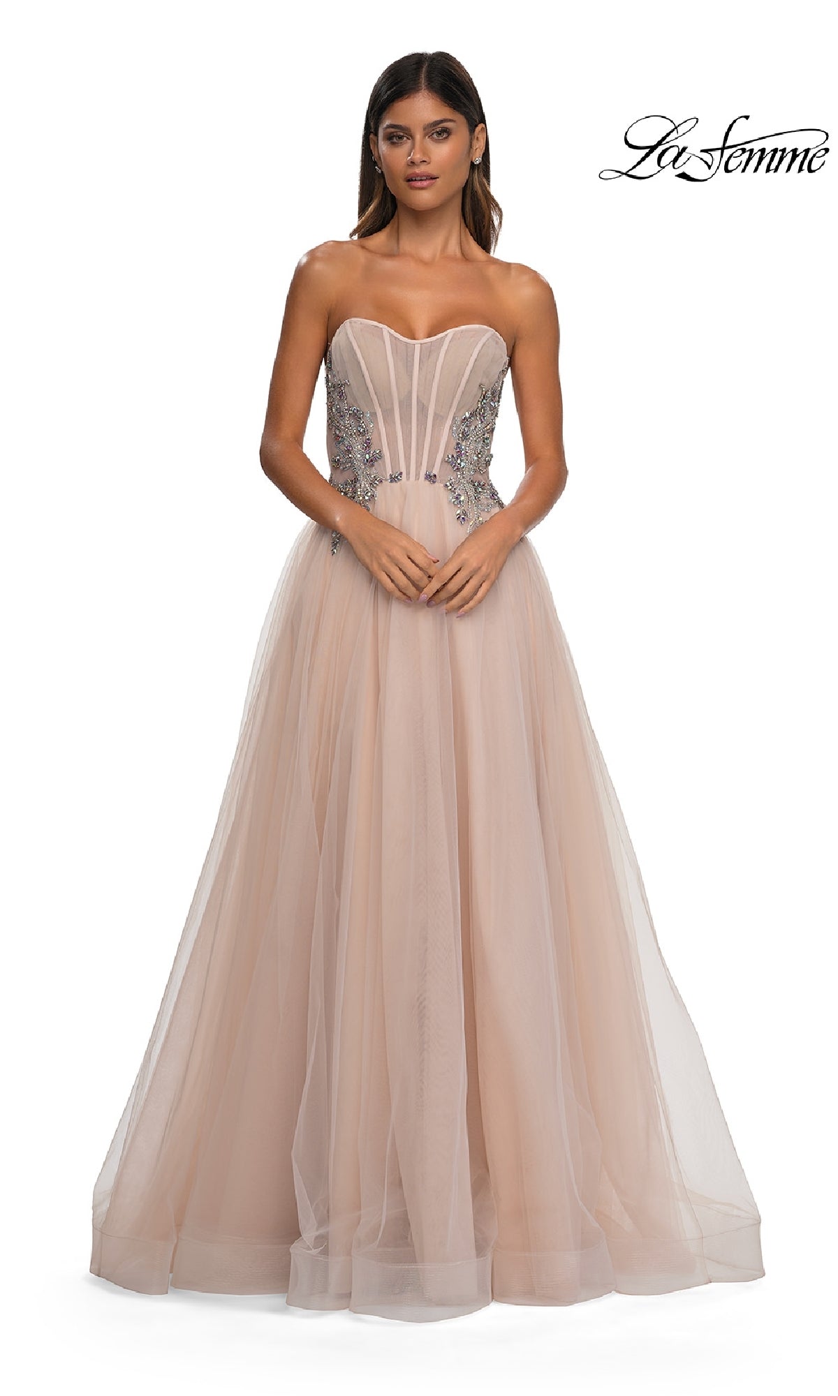 A woman wears the La Femme 32767, a strapless long prom ball gown with a fitted beaded corset bodice featuring silver floral accents and a full, floor-length tulle skirt for an elegant A-line formal look.