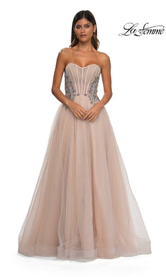 A woman wears the La Femme 32767, a strapless long prom ball gown with a fitted beaded corset bodice featuring silver floral accents and a full, floor-length tulle skirt for an elegant A-line formal look.