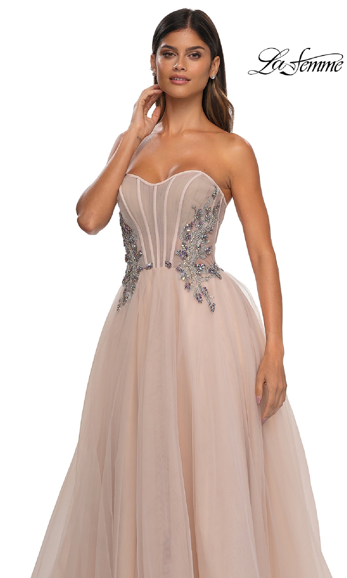 A woman stands against a white background wearing the La Femme 32767 Strapless Long Prom Ball Gown in blush, featuring floral bodice embellishments and an elegant A-line silhouette.