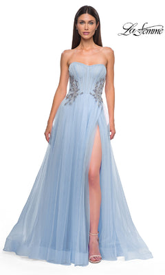 A woman wears the La Femme 32767 strapless long prom ball gown in light blue, featuring a beaded corset bodice, floral embellishments, and a high slit, against a white background.