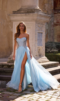 A woman stands gracefully in the Strapless Long Prom Ball Gown: La Femme 32767, the elegant blue dress highlighting her poise.