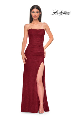 A woman wears the Strapless Long Beaded Prom Dress: La Femme 32773—burgundy, ruched, with a high slit—posing against a white background. The La Femme logo appears in the top right corner.