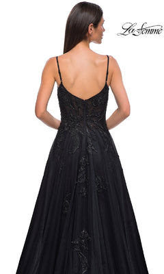 A woman with long dark hair models the La Femme 32781, a long black glitter prom dress with strappy back detail, shown from behind against a white background.
