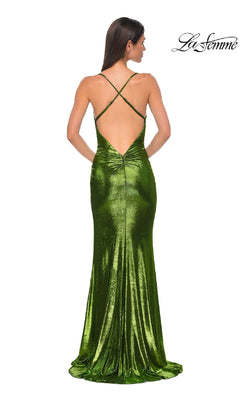 A woman stands with her back to the camera, wearing the La Femme 32782 slinky long metallic prom dress featuring a shiny green finish, criss-cross spaghetti straps, and an open back.