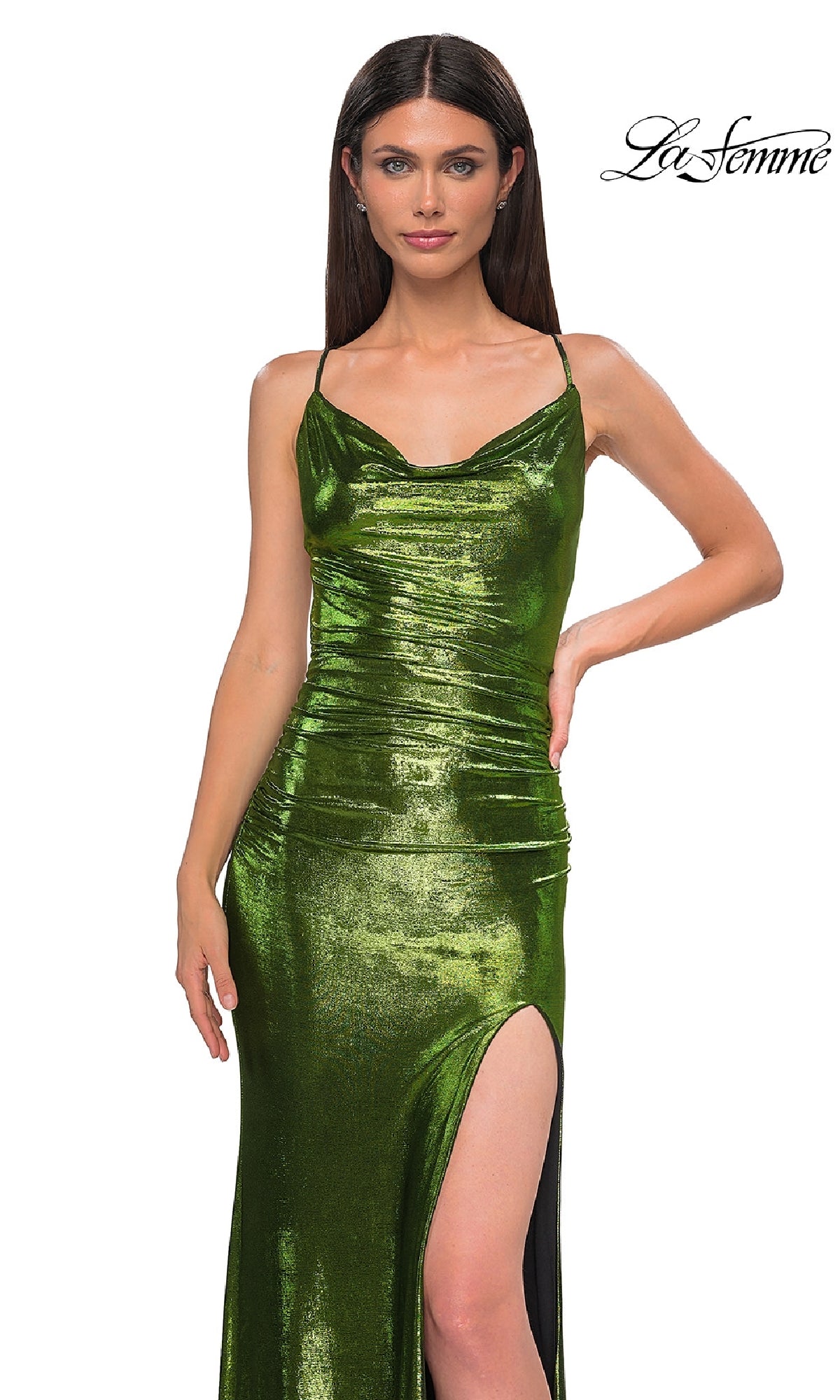 A woman poses against a white background in the La Femme 32782 Slinky Long Metallic Prom Dress, featuring shiny green fabric, spaghetti straps, and a thigh-high slit. The 