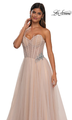 Woman wearing the La Femme 32789 strapless long prom ball gown in blush pink, featuring a sheer sweetheart bodice and silver rhinestone floral waist detail.