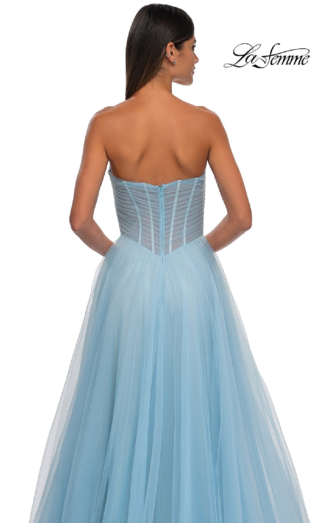 A woman models the La Femme 32789 Strapless Long Prom Ball Gown, featuring a sweetheart bodice and light blue tulle skirt, shown from the back against a white background.