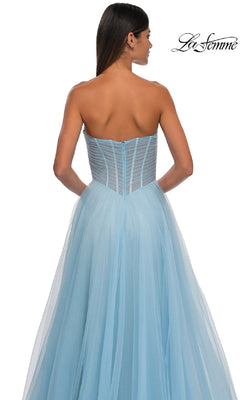 A woman models the La Femme 32789 Strapless Long Prom Ball Gown, featuring a sweetheart bodice and light blue tulle skirt, shown from the back against a white background.