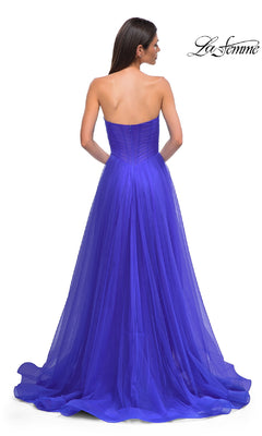 A woman is seen from behind in the La Femme 32789 strapless long prom ball gown with a sweetheart bodice and flowing royal blue tulle skirt. The La Femme logo appears in the top right corner.
